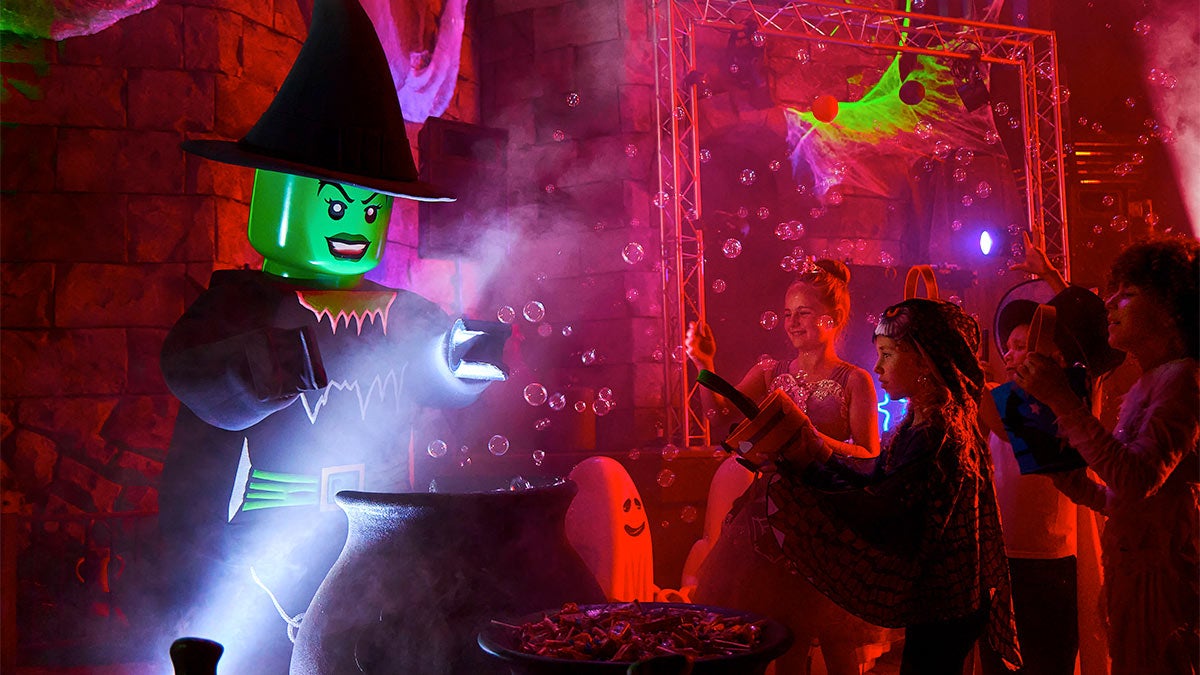 A photo of a kids enjoying the bubbles in the Halloween party